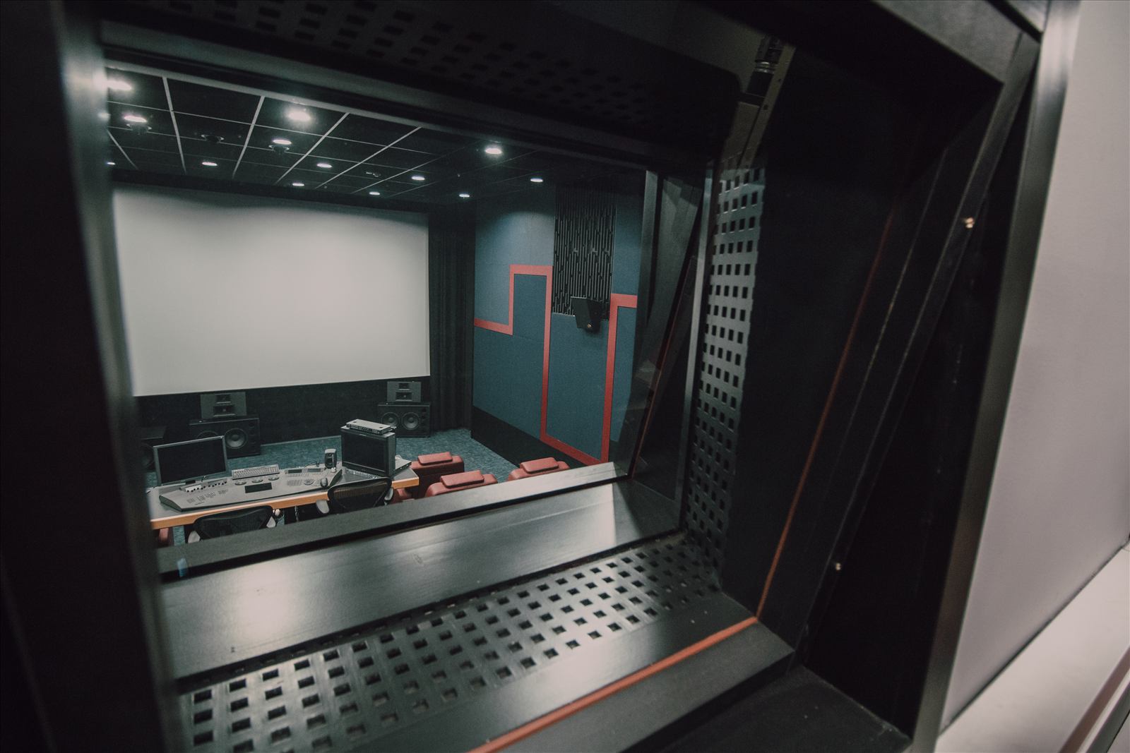Post-production screening room viewed through a projection window